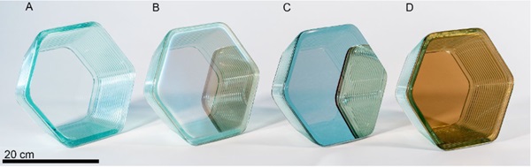 Fig. 8:   Hexagon form printed on high temperature coated float glass A) Antireflective coating B) Optipane C)   Optiview D) Eclipse Gold. Note hexagons B and C show reflections of adjacent samples on their front faces.