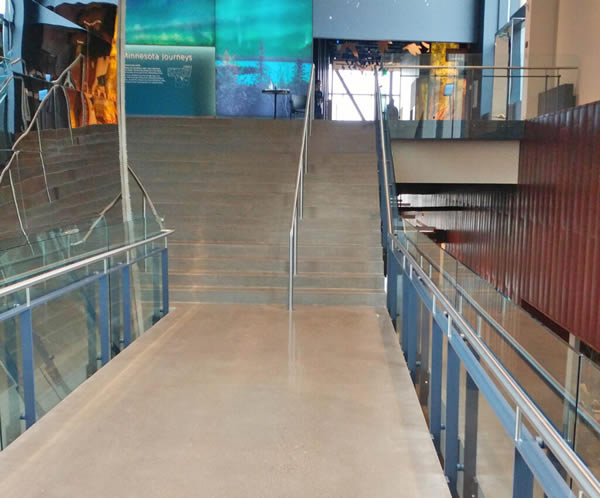 Post Rail with 1/2” tempered clear glass infill ascends the monumental staircase leading to the second-floor exhibit hall.
