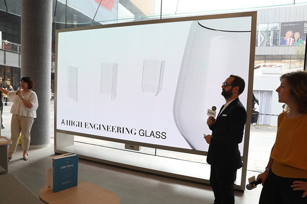 The designer of the flagship store was explaining the inspiration of the hemline glass at the opening event