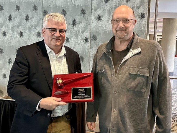 Immediate Past Chair Ron Crowl (left), receives a recognition award from 2024-25 term Chair, Rick Locke (right).