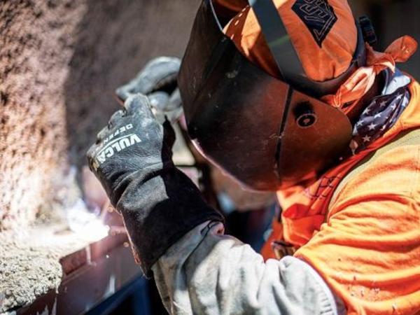 A Nortex Glass & Mirror employee wears a safety shield while working.